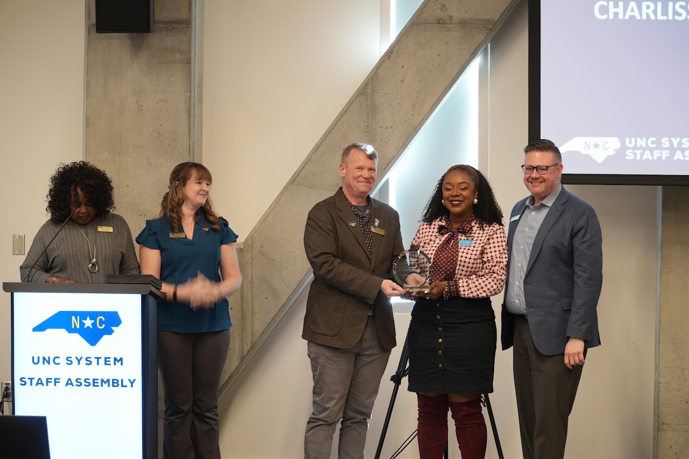 An award presentation at the October 2026 Staff Assembly meeting